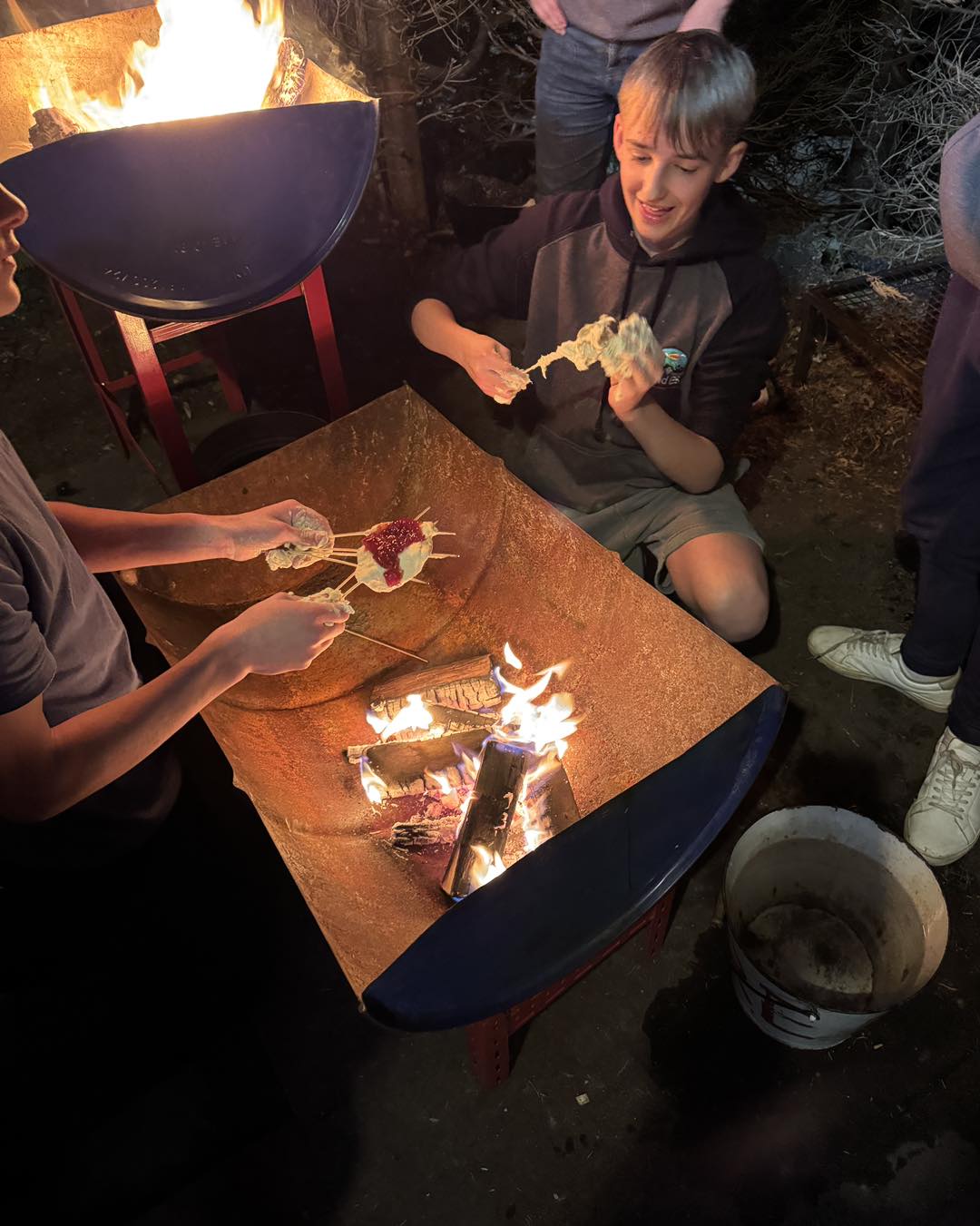 Explorers cooking over a campfire